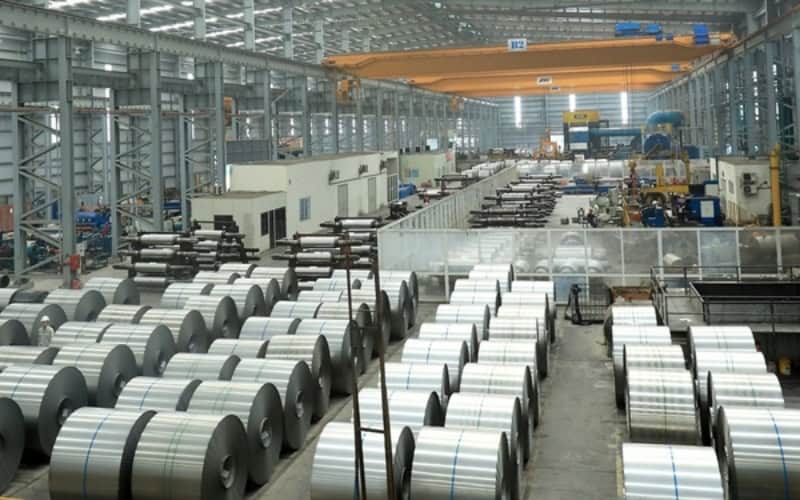Steel fabrication workshop in Vietnam with structural steel components and industrial manufacturing equipment.